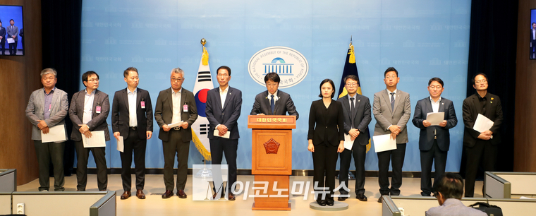 이용우 더불어민주당 의원이 일회용컵 보증금제 라벨지 피해기업과 함께 국회 소통관에서 기자회견하고 있다. (사진=최동환 기자)